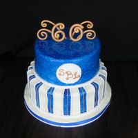 60Th Bday chocolate and vanilla tiered cake paIntbrushed in blue with gold accents in gumpaste
