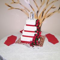 Lisa & Chris Square chocolate, strawberry cakes with raspberry & strawberry filling and iced with vanilla bc. Done on 4th of July. Red silk roses...