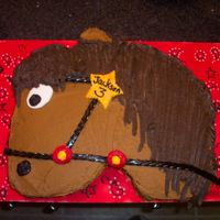 Horse Cut out horse cake with buttercream. Details are fondant & licorice.