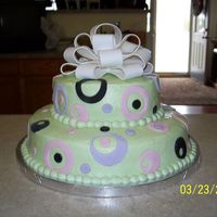 100_0211.jpg Done for a baby shower to coordinate with the invitation. Iced in buttercream. Fondant circle cutouts and bow.