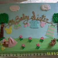100_1336.jpg Clothesline baby shower cake. Iced in buttercream with fondant accents