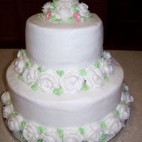 100_0221.jpg Iced in buttercream with buttercream roses. Done for a simple bridal shower.