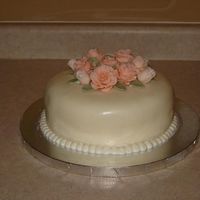 Leigh's Birthday Made this as a gift for my friend's birthday. White chocolate cake with raspberry filling. MMF fondant covered cake, fondant roses....