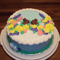 Easter Flower Basket Buttercream with royal flowers and candy bunnies and eggs.