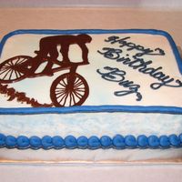 Mountain Bike Yellow cake w/ BC frosting. Mountain Biker done in melted chocolate.