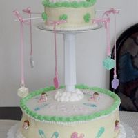 Sleeping Baby Carousel This was my first paid cake. It was for my cousin's babyshower. I made a 12" and a 6" chocolate cake, covered in BC with...