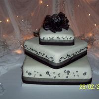 Wedding Cake Three tier wedding cake. Chocolate (mocha mousse), white (french vanilla mousse with chocolate shavings) chocolate (double choc. mousse /w...