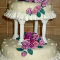 Two Tier Wedding Cake Chocolate cake with chocolate ganache. Covered in MMF with gumtex and 36 roses.