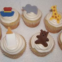 Baby Shower Cupcakes Orange, pineapple cupcakes with marshmallow buttercream.Figures are made with fondant.