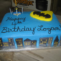 Batsignal Over Gotham City Buildings and signal were made out of MM fondant. This is one of my first times attempting script on a cake, so I had to redo several...