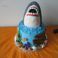 Shark Cake This was fun to do! Shark is RKT covered in fondant with gumpaste teeth. The fish and ocean stuff are made from fondant, sign from gumpaste...