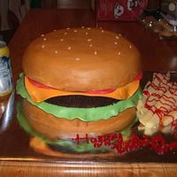 Cheeseburger!! This was so much fun. Two 10" round yellow cakes for the buns and 1 10" round chocolate for the burger. I copied and meshed a few...