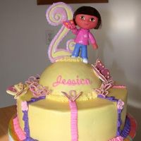 Dora Chocolate cake with chocolate filling, bc icing, and royal icing accents. Dora is a toy though.