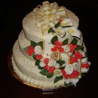College Graduation 3 tiered, amaretto filling, buttercream, all flowers made with fondant/gumpaste including roses, buds & calla lillies