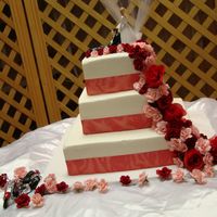 Harley Wedding Bride dragging groom away from Harley. Buttercream with ribbon and silk roses.