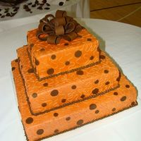 Terracotta Orange And Brown 16, 12, 4 all buttercream with fondant polka dots and bow. Had a bit of an accident while moving it (thanks to husband), but you coudn'...