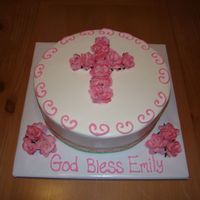 Dedication Cake 10 inch iced in buttercream with ribbon around bottom and silk roses. with buttercream scrolls.