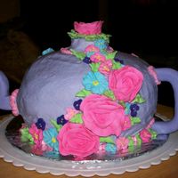 Teapot Teapot cake made with mixing bowls. Fondant spout and handle butter cream icing. Flowers are Royal icing.