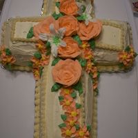 Cross Cross carrot cake with cream cheese icing and with Buttercream flowers. Lilies are Royal icing.