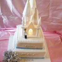 Castlecommunioncake.jpg Battery operated church is the styroform one. 8 and 10inch square cake stacked on top of each other, cripers on the borders.