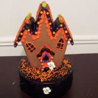 Halloween Cake Wilton's gingerbread house on top of a cake.