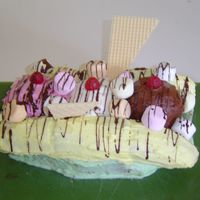 Banana Split The dish is made from chocolate cake. Banana is mini swiss rolls. Ice-cream is three cupcakes. Cherries are raspberry lollies. Marshmallows...