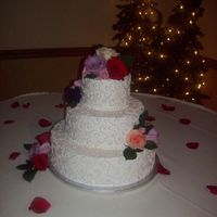 Sand Colored Scroll Work round stacked cakes with sand colored scrollwork and fresh flowers.