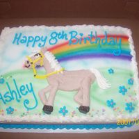 Horse airbrushed rainbow with horse piped on with buttercream.