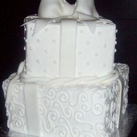 Square Cakes buttercream base with fondant bow and accents. dots and swirls.
