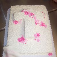 Baptism Cake 1/2 sheet cake with cross and fondant flowers.writting on scroll in bottom left corner.