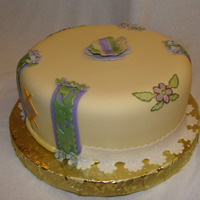 Yellow Cake 8 inch chocolate cake covered in fondant with fondant accents.