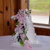 Tara's Cake This is a four tiered stacked cake iced in BC with silk flowers