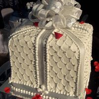 Gift Box a three flavored (mocha, chocolate, butter) wedding cake covered in vanilla flavored fondant, decorated with royal icing and real ribbons(...