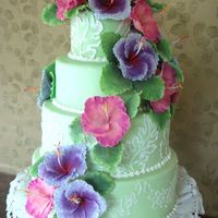 Another Hawaiian Themed Cake always my forte, the creation of gumpaste hibiscus. a three tiered butter cake covered in pale green vanilla fondant.