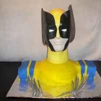Wolverine Cake shoulders covered with fondant. Wolverine's head is a man's styrofoam head painted with glow in the dark paint and sheet...