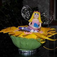Flower Fairy Flower and fairy made from gumpaste. Wings made with gelatin. Cake inside flower made with 1/2 ball pan.