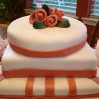 Pink Roses I was trying to practice for an upcoming cake and just came up with this design. Had fun making it. The roses are made from fondant.