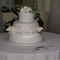 White Wedding So here it is my 1st wedding cake. Tell me what you think! Next time I will do something with the base. Its way to plain, I thought the...