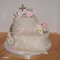 Christening Dress This cake is 2 ovals covered in fondant, the dress is made of fondant also, the flowers are gumpaste. I did 2 cakes this weekend both in...