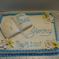 Confirmation Cake This confirmation cake is frosted with butter cream frosting and the book is made of fondant, the flowers are gum paste.