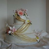 Micheles Shower This is a 14, 10, 6 with MMF fondant swags dust with gold dust, and roses, cala lillies and cattelya's. I hope you like it.