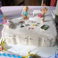 Making Cookies This cake is covered in fondant with (I cheated, because I am not good at making figurines) doll house accents on it. It is a counter with...