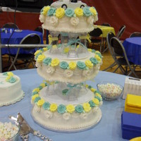 Turquiose And Yellow Wedding Cake my second wedding cake, first time using tiers like that. i made around 60 roses of each color from royal icing. also my first time using...