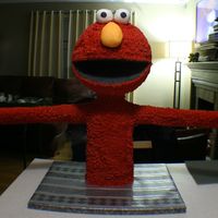Elmo Serves Up Cake He stands about thirty inches tall and his hands were about four feet apart at the cakes. his head was made with a ten inch, three layer...