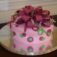 Dots And Bow Birthday cake for a friend. White cake with almond flavoring. She wanted fondant in pink and green. I found the ribbon that's along...