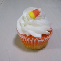 Candy Corn Cupcake Used white cake batter dyed yellow, then layerd orange over it to bake...white whipped buttercream icing and a candy corn top.