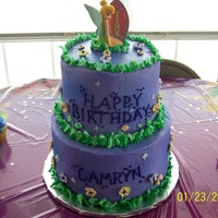 Tink Cake All buttercream with royal icing flowers - inspired by a wilton yearbook cake. Used a tink candle and cupcakes with tink picks...