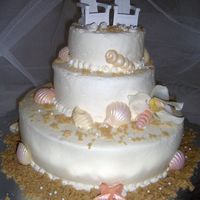 Beach Cake Three tier beach cake for a bridal shower. The chairs on top are place card holders from a bridal site. Iced in buttercream with chocolate...