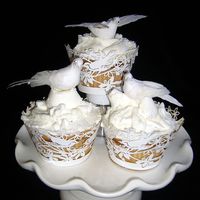 P1130196_Edited.jpg White cupcakes with miniature birds, wrapped in bird cupcake wraps from fancy flours