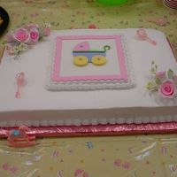 Girl Baby Buggy White cake with buttercream icing, gumpaste roses and fondant hand made buggy for center plaque. Saw it in a magazine and gave it a try.